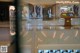 A view of a shopping mall through a glass door.