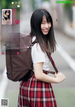 A young woman in a school uniform with a backpack.