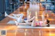 A couple of women doing stretching exercises in a gym.