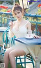 A woman sitting at a table with a cup of coffee.