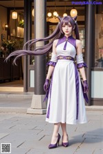 A woman in a white and purple dress is standing on a sidewalk.