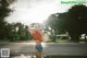 A woman taking a picture of herself in a puddle of water.